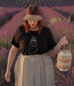femme qui porte un t-shirt noir loose coyoqui dans un champ de lavande