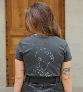 femme posant de dos portant un tshirt gris qui represente la déesse egyptienne sekhmet