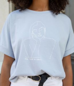 Une femme portant un t-shirt loose bleu clair de la collection diosas Themis de la marque lyonnaise féministe éthique éco-responsable LEONOR ROVERSI
